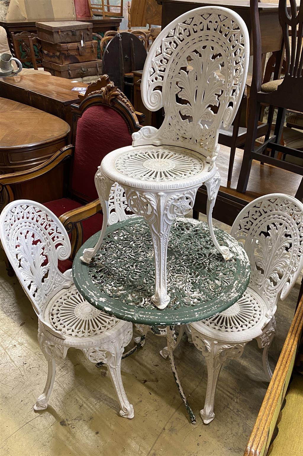 A circular painted aluminium garden table, diameter 68cm together with a set of four painted garden chairs